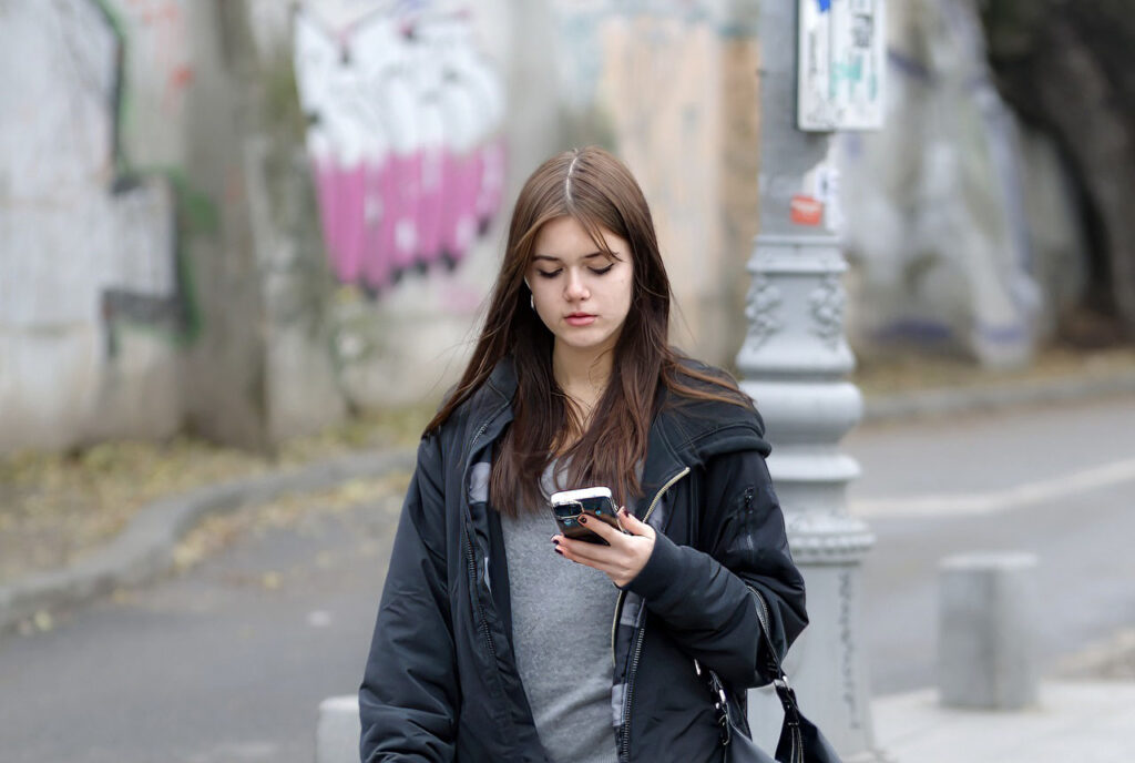 a woman checking an online store website while walking on the street